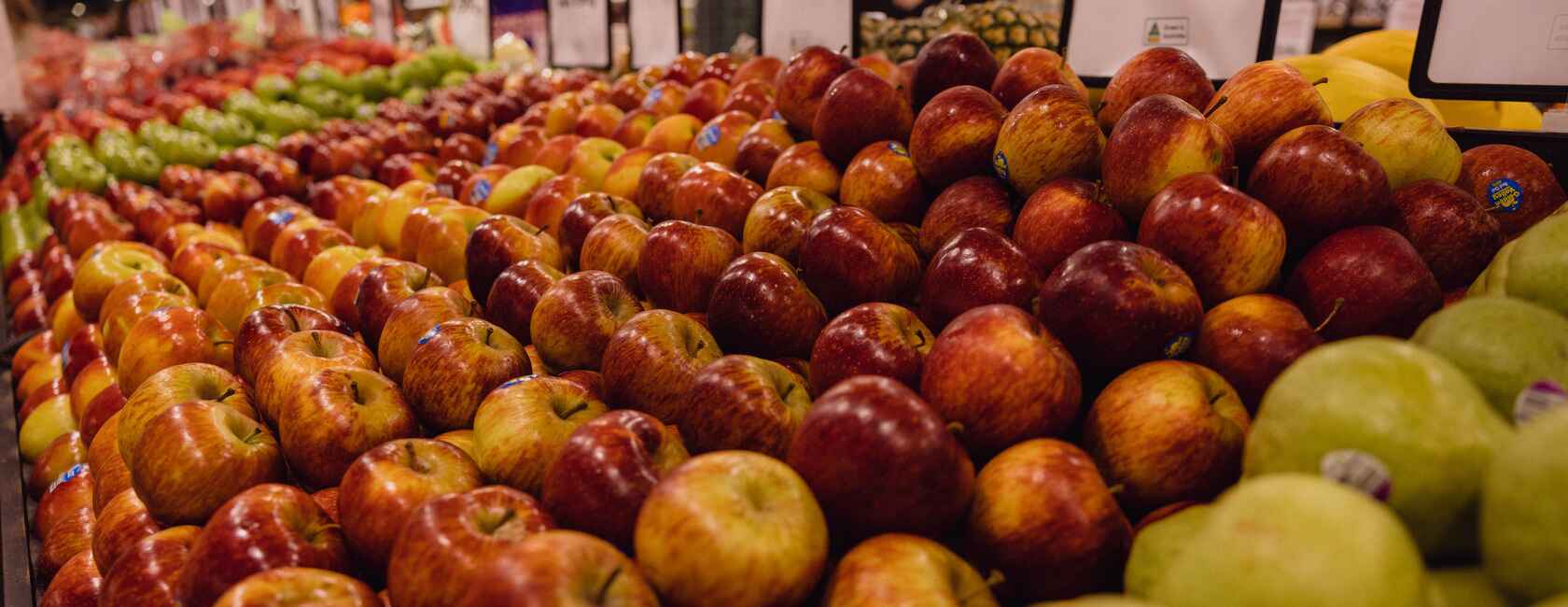 Display of a variety of apples including Red Delicious to Granny Smiths.