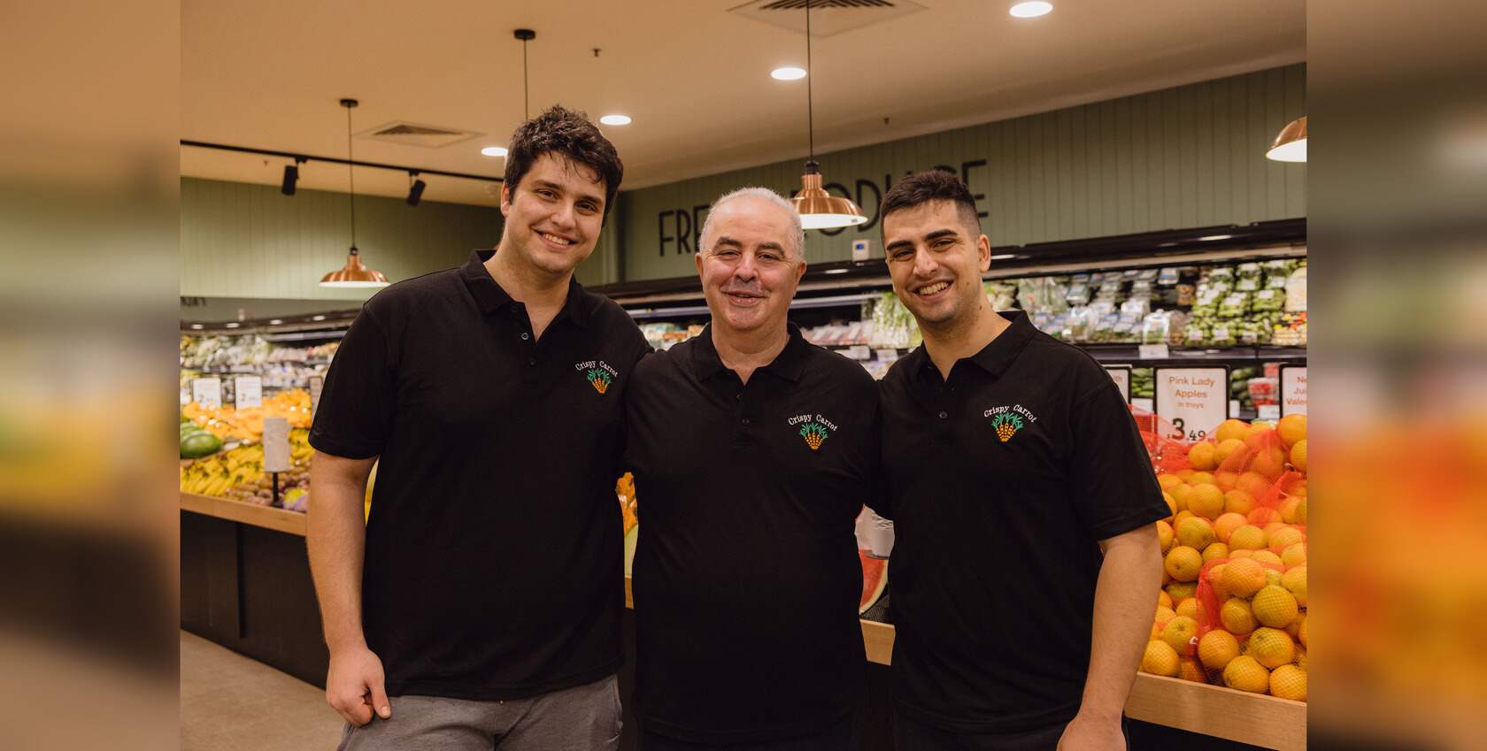 Family photo of the owner Sam in between his sons, Chris (left) and Emile (right) inside the Crispy Carrot store.