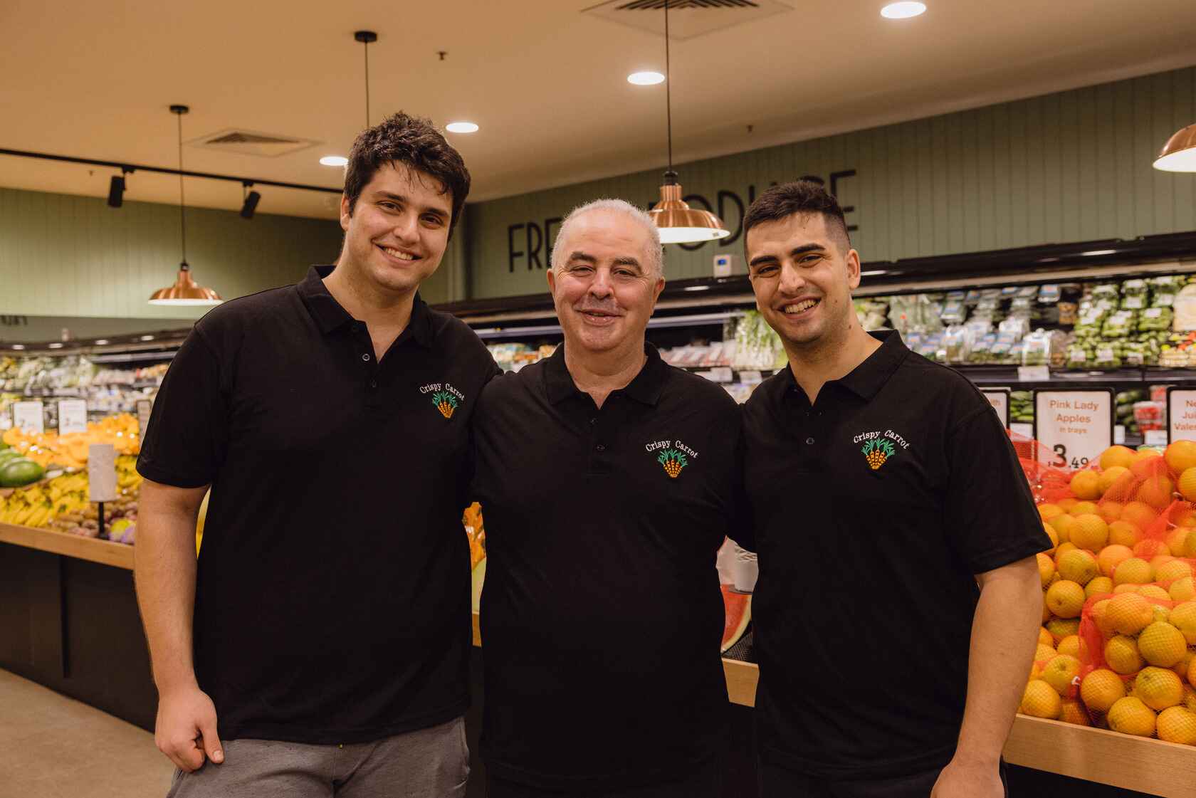 Family photo of the owner Sam in between his sons, Chris (left) and Emile (right) inside the Crispy Carrot store.