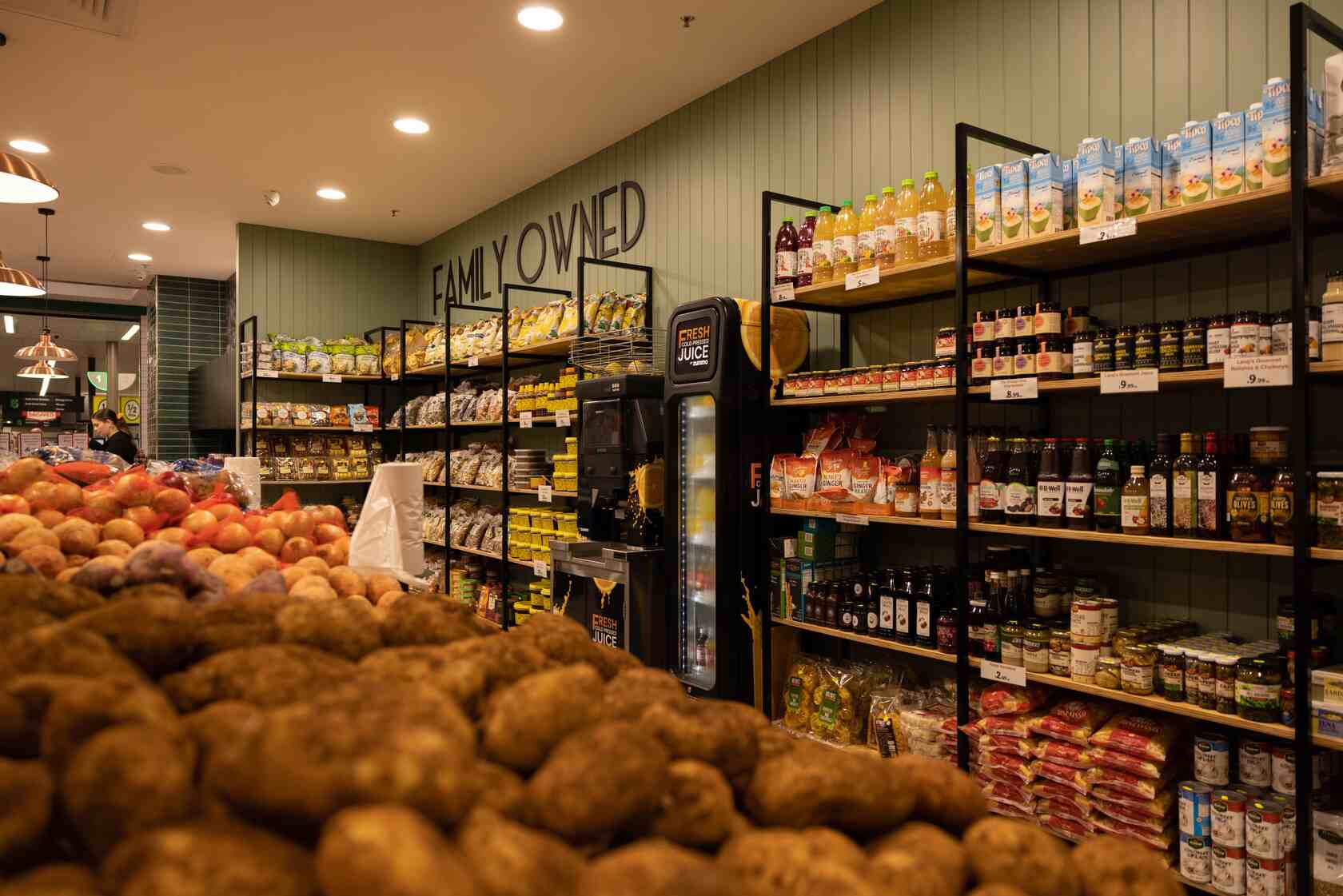 Display of a wide variety of grocery items such as nuts, honey and pickled goods.