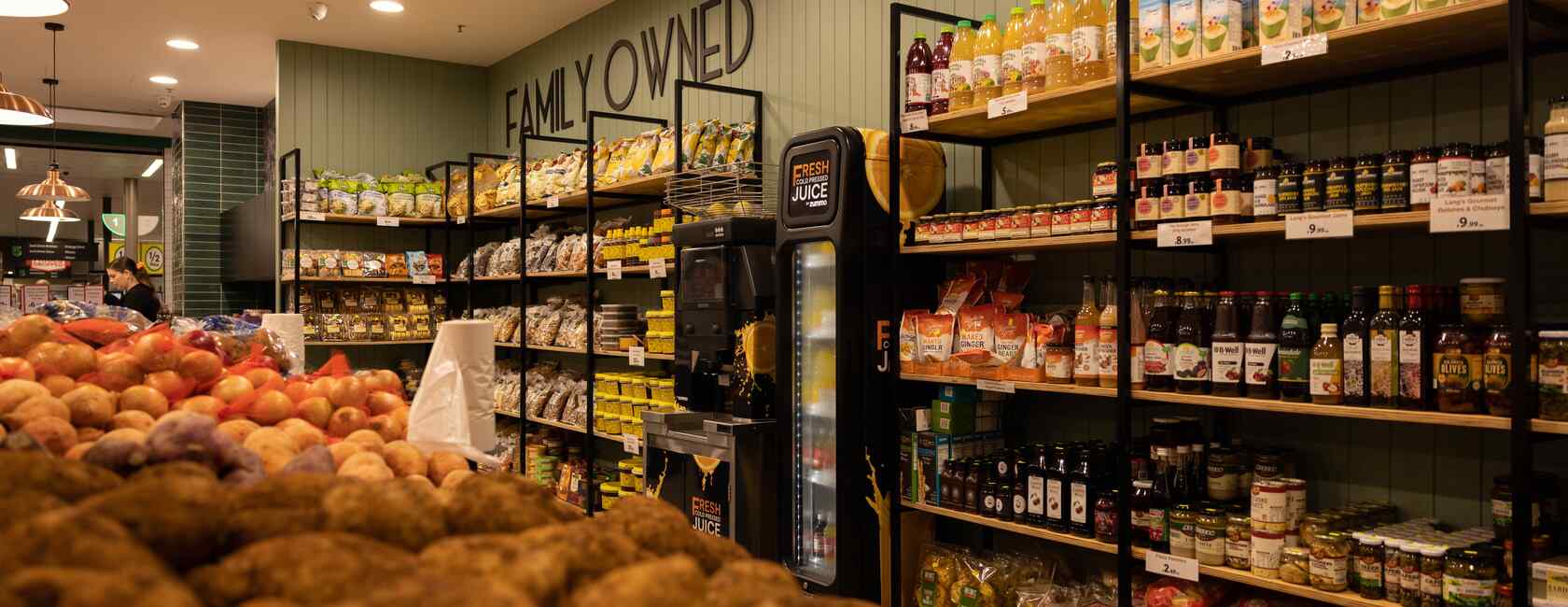 Display of a wide variety of grocery items such as nuts, honey and pickled goods.